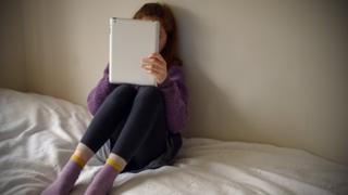 Girl looking at computer tablet