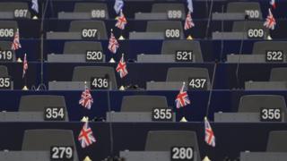 UK flags on desks in the European Parliament