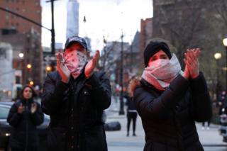 Members of the public applaud medical workers in New York's Manhattan district, April 10