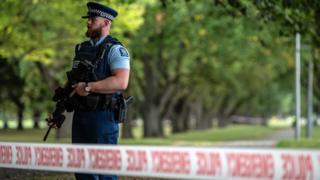 A police officer carrying an automatic rifle guards the area near Al Noor mosque on March 17, 2019 in Christchurch, New Zealand