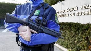 A Swiss police officer on patrol outside the Russian mission in Geneva