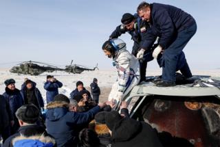 in_pictures NASA astronaut Christina Koch is helped shortly after the landing of the Russian Soyuz MS-13 space capsule