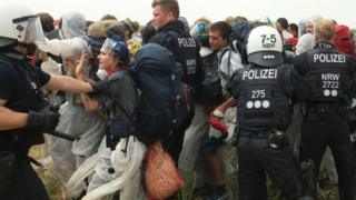 Police attempting to stop the activists from entering the mine