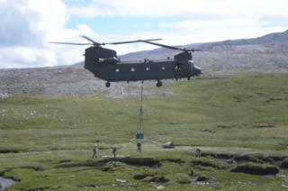 Helicopter carrying the Ben More Asynt grave into place