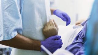 Doctor holding patient's wrist