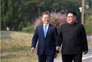 North Korea"s leader Kim Jong Un (R) and South Korea"s President Moon Jae-in (L) walk together after a tree-planting ceremony at the truce village of Panmunjom on April 27, 2018. The leaders of the two Koreas held a landmark summit on April 27 after a highly symbolic handshake over the Military Demarcation Line that divides their countries, with the North"s Kim Jong Un declaring they were at the "threshold of a new history". / AFP PHOTO / Korea Summit Press Pool / Korea Summit Press PoolKOREA SUMMIT PRESS POOL/AFP/Getty Images