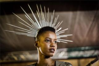 A model prepares backstage during the fashion preview and concert show for the pre-Durban July Handicap horse race on June 30, 2018 in Durban.
