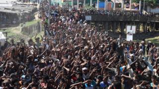 Сотни беженцев протестуют с руками в воздухе