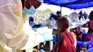 A Congolese health worker administers an Ebola vaccine to a child in the Democratic Republic of Congo