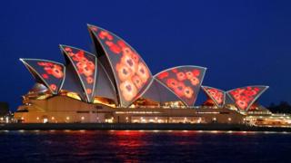Red poppies are projected on to the sails of the Sydney Opera House