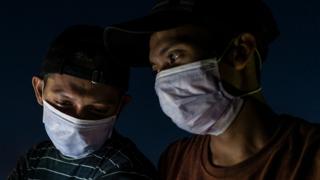 Two men wearing masks in Aceh