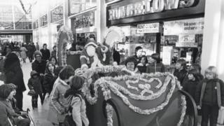 Father Christmas on his sleigh going through the shopping centre