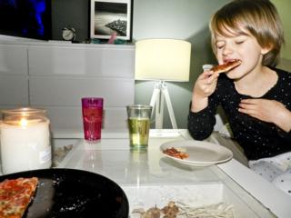girl eating pizza