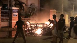 Protesters burn motorcycles in front of a provincial office in Vietnam's coastal Binh Thuan province