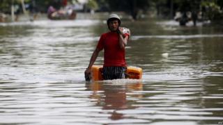 Man wades through floodwater outside Kale township in Sagaing, Myanmar (3 Aug 2015)
