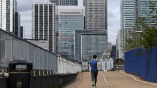 A jogger runs through a quiet Canary Wharf