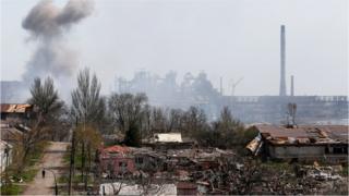 Smoke rises above a plant of Azovstal Iron and Steel Works company and buildings damaged in the course of Ukraine-Russia conflict in the southern port city of Mariupol, Ukraine 18 April 2022