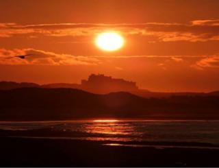 Castle by sea at sunset