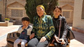 Dilrabo and her daughter and granddaughter relaxing after praying at the Daniyar shrine