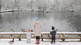 LANCASHIRE - JANUARY 30: Matilda, 2 (L) and Oliver, 3, feed the ducks with their mother in Stalybridge Country park on January 30, 2019 in Lancashire, United Kingdom