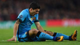 Luis Suarez of Barcelona holds his injured leg