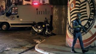 A policeman stands guard outside the Corinthians fans "Hall 9" headquarters after the shooting