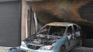 A car reversed through the metal shutter of the hairdressers
