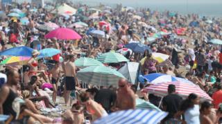 People enjoy the hot weather at Southend beach in Essex. PA Photo. Picture date: Saturday August 8, 2020