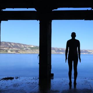 The Antony Gormley sculpture on Folkestone Harbour Arm in Kent