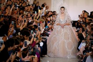 A model presents a wedding dress by designer Elie Saab as part of his Haute Couture Fall/Winter 2018/2019 fashion show in Paris, France, July 4, 2018
