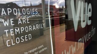 A sign in the window of a Vue cinema in Altrincham, Greater Manchester