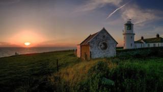A lighthouse at sunset