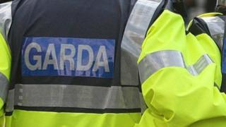An officer wearing a coat marked: Garda