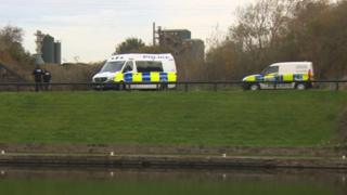Police vans by river