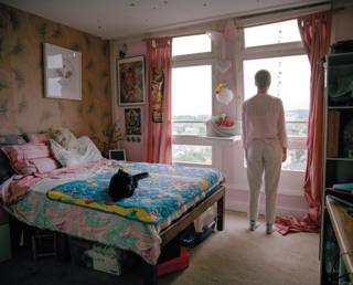 Molly looks out of her bedroom window