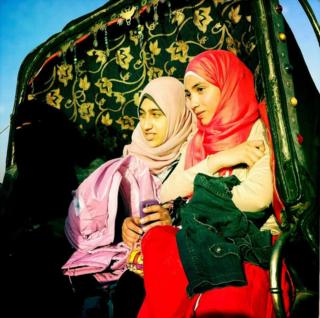 Two women in a horse carriage