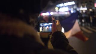 A man is seen taking a picture with his smartphone in Paris. 26 Jan 2019