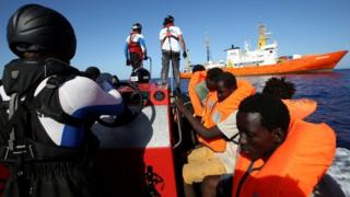 Migrants in life jackets are pictured during a rescue by the charity SOS Méditerranée