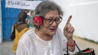 Tunisian woman shows her inked finger after casting her vote at a polling station during the presidential elections in Tunis, Tunisia on September 15, 2019.