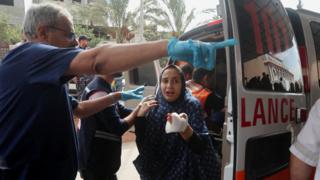 Injured woman arrives at hospital in Khan Younis, Gaza, 16 October