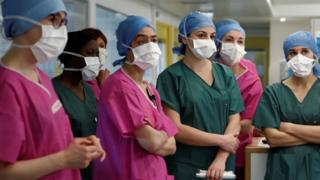 Medical staff wearing face masks attend a briefing at the Institut Mutualiste Montsouris (IMM) hospital in Paris, France (6 April 2020)