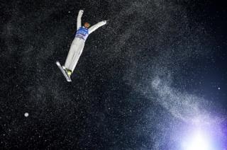 Qi Guangpu of China performs an aerial during the FIS Snowboarding and Freestyle Skiing World Championships.