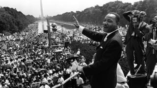 US civil rights leader Martin Luther King waving from the steps of the Lincoln Memorial to supporters on the Mall in Washington, DC in 1963