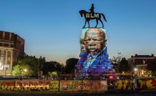 John Lewis projected on to Robert E Lee statue