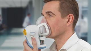 A volunteer using the breath test facemask