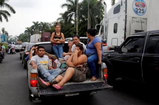 Displaced people leave an area affected by the eruption of Fuego volcano in Escuintla, Guatemala