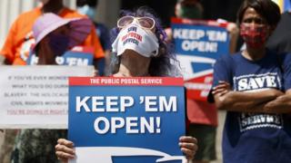 People protest in support of the US Postal Service in New York on Monday