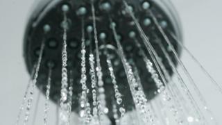 Water flows from a bathroom shower head