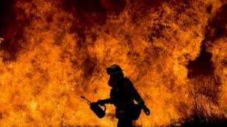 A firefighter battling the flames