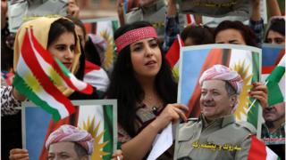 Iraqi Kurdish students hold posters of Iraqi Kurdish leader Massud Barzani during a protest in his support in Arbil, the capital of Iraqi Kurdistan, on October 30, 2017.